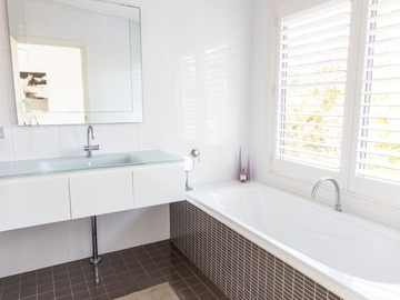 Renting out with online payment: Pristine White Bathroom with Feature Tiles